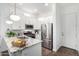 Modern kitchen featuring white cabinetry, stainless steel appliances, granite countertops, and a breakfast bar area at 21716 E Waverly Dr, Queen Creek, AZ 85142