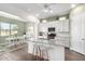Bright kitchen with granite counters, white cabinets, stainless appliances, and a cozy breakfast nook at 21716 E Waverly Dr, Queen Creek, AZ 85142