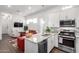 Open-concept kitchen with white cabinets, granite countertops, stainless steel appliances, and adjacent living area at 21716 E Waverly Dr, Queen Creek, AZ 85142