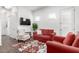 Stylish living room with comfortable seating, mounted TV, and easy access to the outside at 21716 E Waverly Dr, Queen Creek, AZ 85142