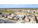 Aerial perspective of a sprawling suburban community featuring tiled roofs and desert landscape at 21716 E Waverly Dr, Queen Creek, AZ 85142