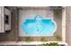 Aerial view of backyard pool with blue water and tropical landscaping at 21716 E Waverly Dr, Queen Creek, AZ 85142