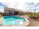 Backyard pool and surrounding deck with lush landscaping, a safety fence, and a view of the home's exterior at 21716 E Waverly Dr, Queen Creek, AZ 85142