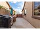 Long side yard with concrete, grill, and wooden gate at 21716 E Waverly Dr, Queen Creek, AZ 85142