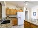 Kitchen features granite counters, sink, and a refrigerator at 24616 S Starcrest Dr, Sun Lakes, AZ 85248