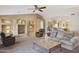 Bright living room with built-in shelving and a cozy seating area at 24616 S Starcrest Dr, Sun Lakes, AZ 85248