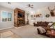 Spacious living room with a rustic fireplace and large TV at 2688 E Joy Dr, San Tan Valley, AZ 85140