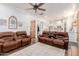 Open living room with brown couches and view of kitchen at 2688 E Joy Dr, San Tan Valley, AZ 85140