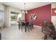 Bright dining room with a dark wood table and access to the backyard at 26916 W Potter Dr, Buckeye, AZ 85396