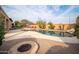 Relaxing pool area with fire pit and brick patio at 26916 W Potter Dr, Buckeye, AZ 85396