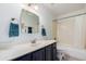 Bathroom features a single vanity, mirror, and tub with shower at 2715 W Calle Del Norte Dr, Chandler, AZ 85224