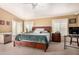 A well-lit bedroom with a large king bed, a ceiling fan, and multiple windows overlooking the backyard at 2715 W Calle Del Norte Dr, Chandler, AZ 85224