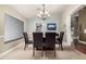 Formal dining room with a glass-top table, modern chandelier, and large window for natural light at 2715 W Calle Del Norte Dr, Chandler, AZ 85224