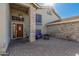 Inviting front patio with brick pavers, seating area and attractive stained wood front door at 2715 W Calle Del Norte Dr, Chandler, AZ 85224
