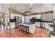 This kitchen features stainless steel appliances, a center island, white cabinets and hardwood floors at 2715 W Calle Del Norte Dr, Chandler, AZ 85224