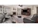 Comfortable living room featuring a fireplace, built-in entertainment center, and wood flooring at 2715 W Calle Del Norte Dr, Chandler, AZ 85224