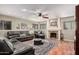 Cozy living room featuring a fireplace, ceiling fan, and plush seating for ultimate comfort at 2715 W Calle Del Norte Dr, Chandler, AZ 85224