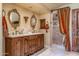 Bathroom featuring double vanity, shower, and rich fabrics at 29 E Oakwood Hills Dr, Chandler, AZ 85248