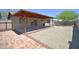 Backyard with covered patio, concrete area, and low-maintenance rock landscaping at 2949 E Willow Ave, Phoenix, AZ 85032