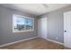 Bedroom with wood floors, large window, and sliding door at 2949 E Willow Ave, Phoenix, AZ 85032