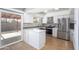 Modern kitchen with island, stainless steel appliances, and white cabinets at 2949 E Willow Ave, Phoenix, AZ 85032