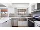 Modern kitchen features stainless steel appliances and white shaker cabinets at 2949 E Willow Ave, Phoenix, AZ 85032