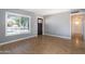 Living room with wood floors, large window and door to hallway at 2949 E Willow Ave, Phoenix, AZ 85032