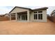 Backyard with a covered patio, sliding glass doors, and large windows at 32464 N 134Th Ln, Peoria, AZ 85383