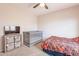 Bedroom with crib, bed, dresser, and ceiling fan at 32504 N Cherry Creek Rd, San Tan Valley, AZ 85144