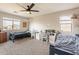 Bedroom with two beds, a study area, and ceiling fan at 32504 N Cherry Creek Rd, San Tan Valley, AZ 85144