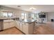 Kitchen with an island, white cabinets, and stainless steel appliances at 32504 N Cherry Creek Rd, San Tan Valley, AZ 85144