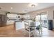Open concept kitchen with an island, stainless steel appliances, and a dining area at 32504 N Cherry Creek Rd, San Tan Valley, AZ 85144