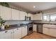 Kitchen with white cabinets, stainless steel appliances, and a farmhouse sink at 32504 N Cherry Creek Rd, San Tan Valley, AZ 85144