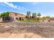 Expansive backyard featuring a lush lawn, desert landscaping, a trampoline, and a built-in barbecue area at 32504 N Cherry Creek Rd, San Tan Valley, AZ 85144