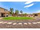 Lush backyard featuring desert landscaping, a built-in BBQ, covered patio and a refreshing in-ground pool with safety fence at 32504 N Cherry Creek Rd, San Tan Valley, AZ 85144