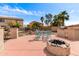 Outdoor patio with a custom built-in BBQ area, firepit, and dining set surrounded by desert landscaping at 32504 N Cherry Creek Rd, San Tan Valley, AZ 85144