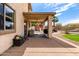 Covered patio with ample space for entertaining, overlooking a well-maintained backyard and refreshing pool at 32504 N Cherry Creek Rd, San Tan Valley, AZ 85144