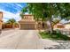 Charming two-story home with a tile roof, stone accents, a well-manicured lawn, and a spacious driveway at 32504 N Cherry Creek Rd, San Tan Valley, AZ 85144