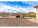 Inviting in-ground pool with rock waterfall feature, safety fence, and desert landscaping at 32504 N Cherry Creek Rd, San Tan Valley, AZ 85144
