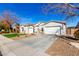 House exterior showcasing a two-car garage and manicured lawn at 3332 E Powell Pl, Chandler, AZ 85249