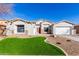 One-story home with a landscaped yard, two-car garage, and neutral exterior at 3332 E Powell Pl, Chandler, AZ 85249