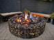 Stone fire pit with seating area at night at 3332 E Powell Pl, Chandler, AZ 85249