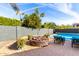 Fire pit with seating area in a landscaped backyard at 3332 E Powell Pl, Chandler, AZ 85249