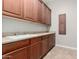 Laundry room with cabinets and a utility sink at 3332 E Powell Pl, Chandler, AZ 85249