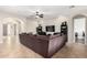 Living area with sectional sofa, tile floors, and views to other rooms at 3332 E Powell Pl, Chandler, AZ 85249