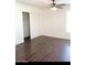 Bedroom with dark wood flooring, ceiling fan, and closet at 3840 N 43Rd Ave # 75, Phoenix, AZ 85031