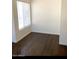 Bedroom with dark wood flooring and large window at 3840 N 43Rd Ave # 75, Phoenix, AZ 85031