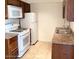 Bright kitchen featuring white appliances and wood cabinets at 3840 N 43Rd Ave # 75, Phoenix, AZ 85031