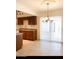 Eat-in kitchen with wood cabinets, tiled floor and chandelier at 3840 N 43Rd Ave # 75, Phoenix, AZ 85031