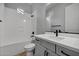 Modern bathroom with soaking tub, gray vanity, and black matte fixtures at 4275 E Bernice E St, Gilbert, AZ 85295